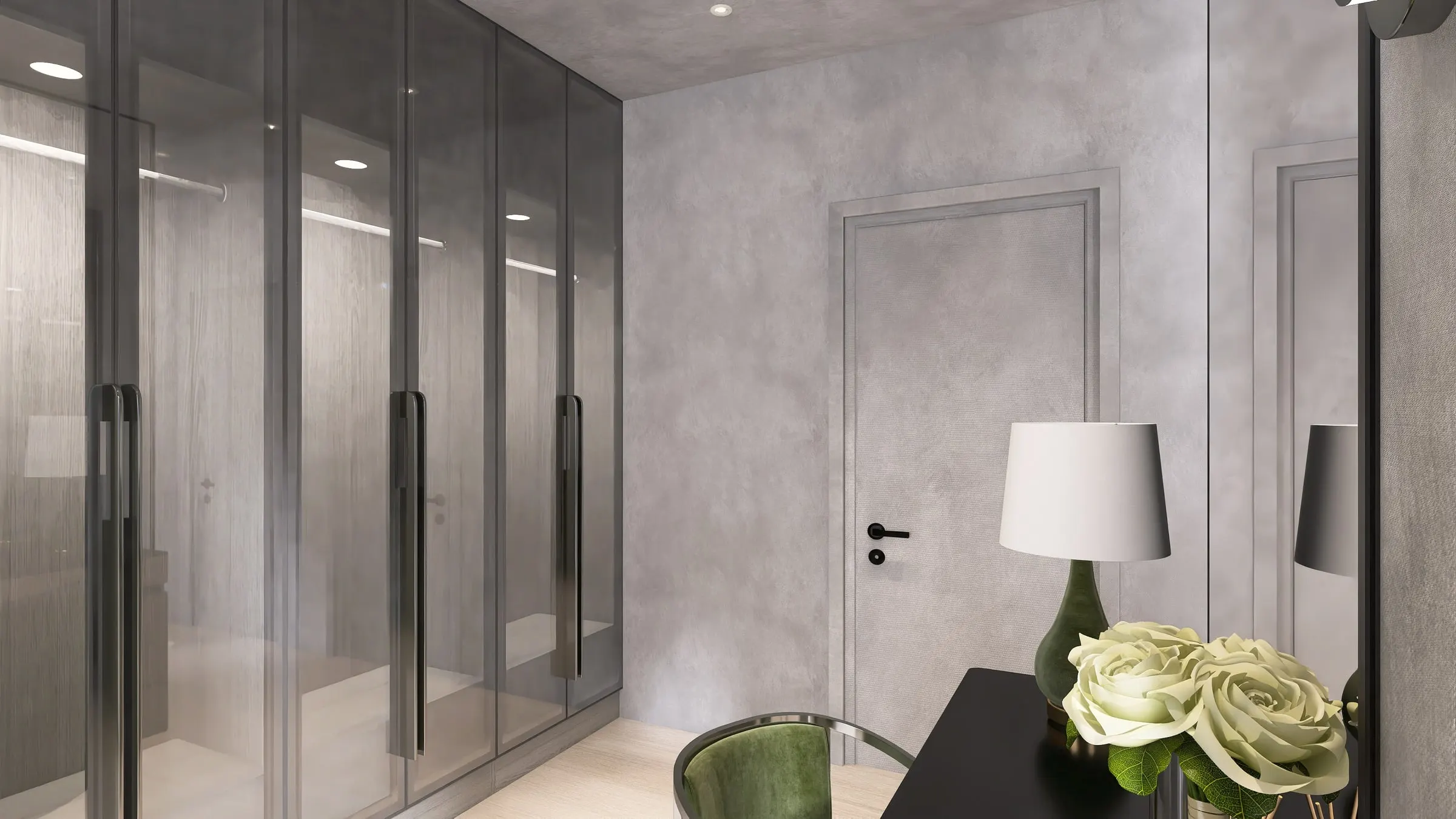 Dressing area with glass wardrobe wall, table lamp and roses on a black table