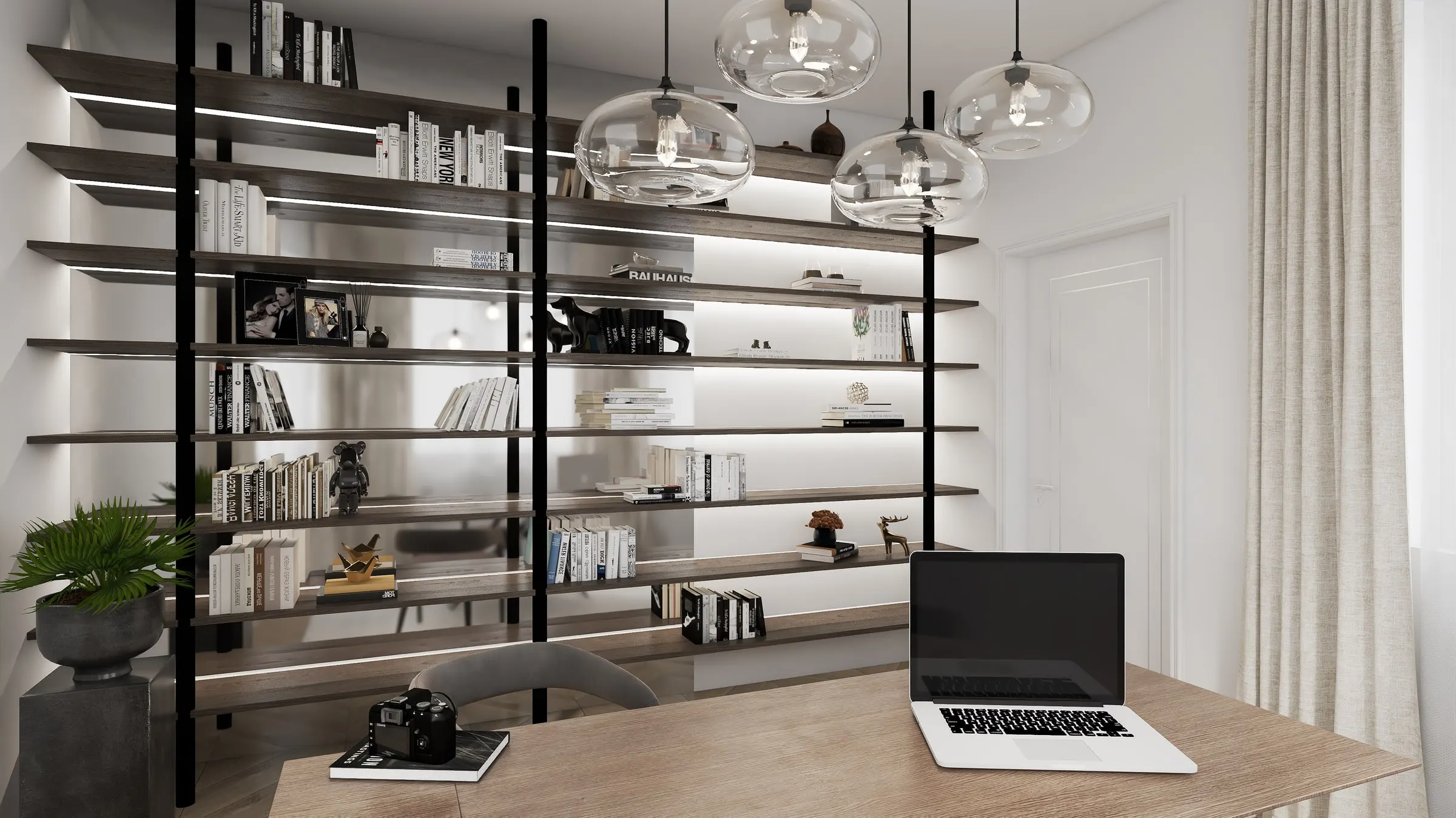 Home office with wooden desk in front of an illuminated bookshelf