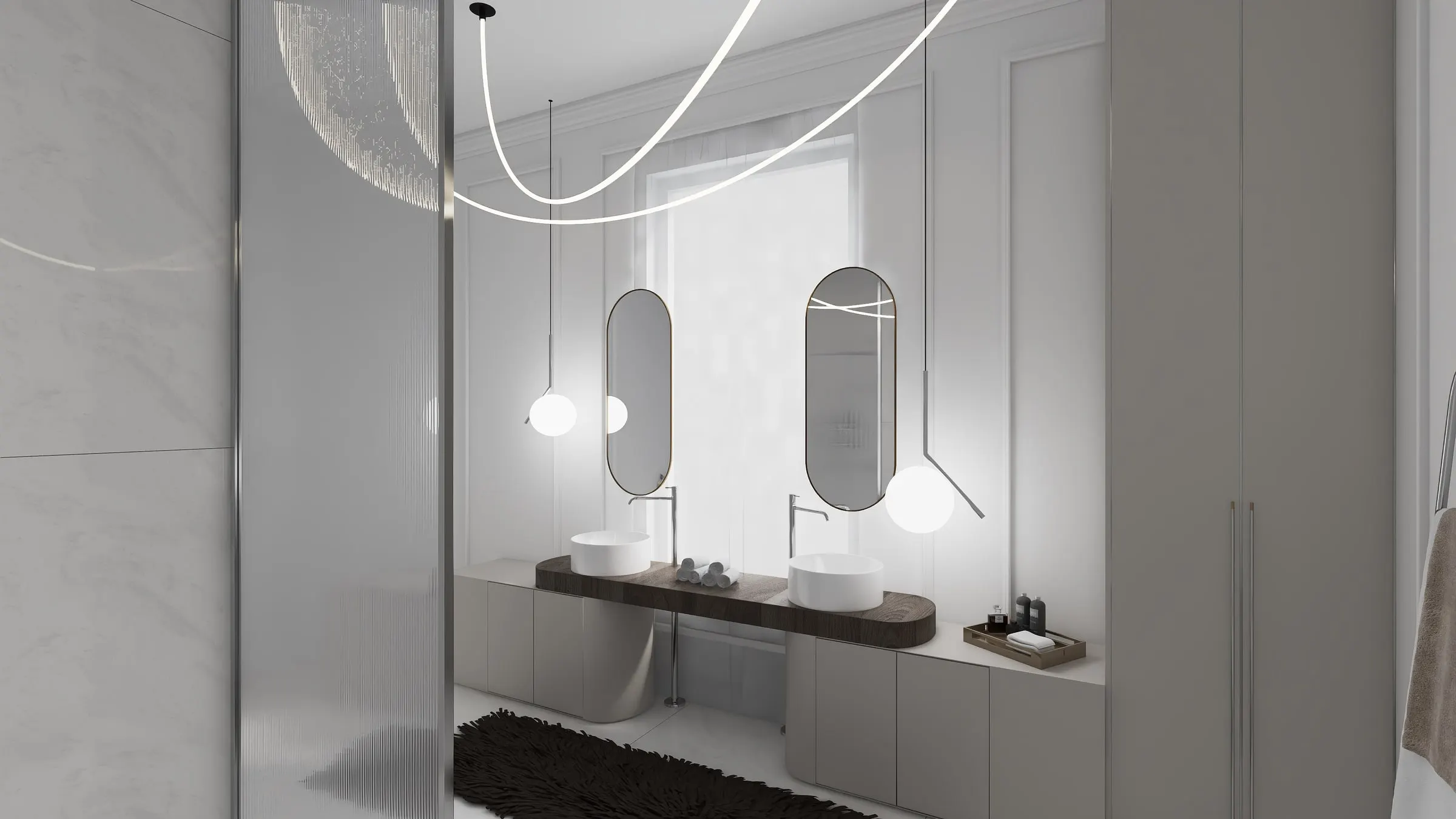 Bathroom with double vanity, oval mirrors and a curved light strip on the ceiling